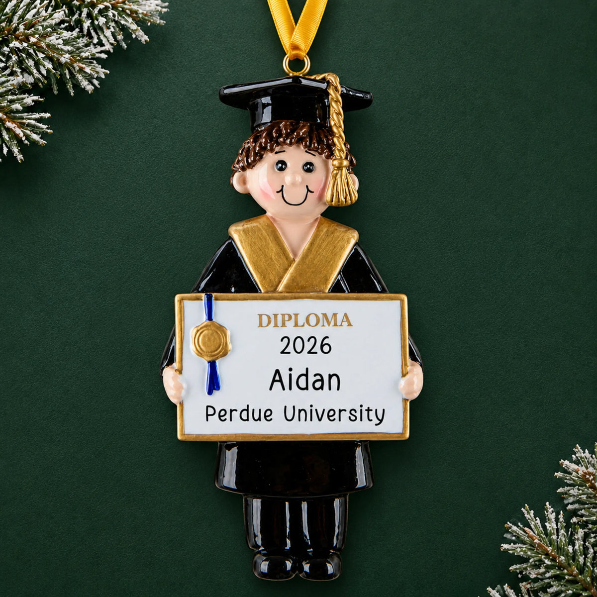 Personalized graduation boy Christmas ornament in black cap and gown holding a diploma with name, school and year