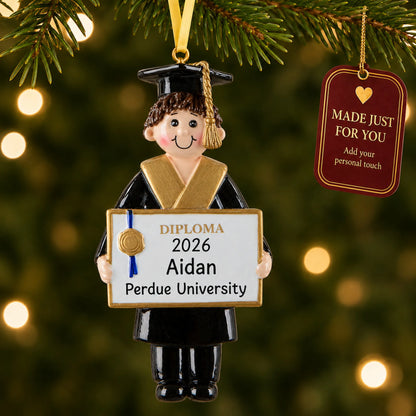 Personalized graduation boy Christmas ornament hanging by a gold ribbon among tree lights with a Made Just For You tag
