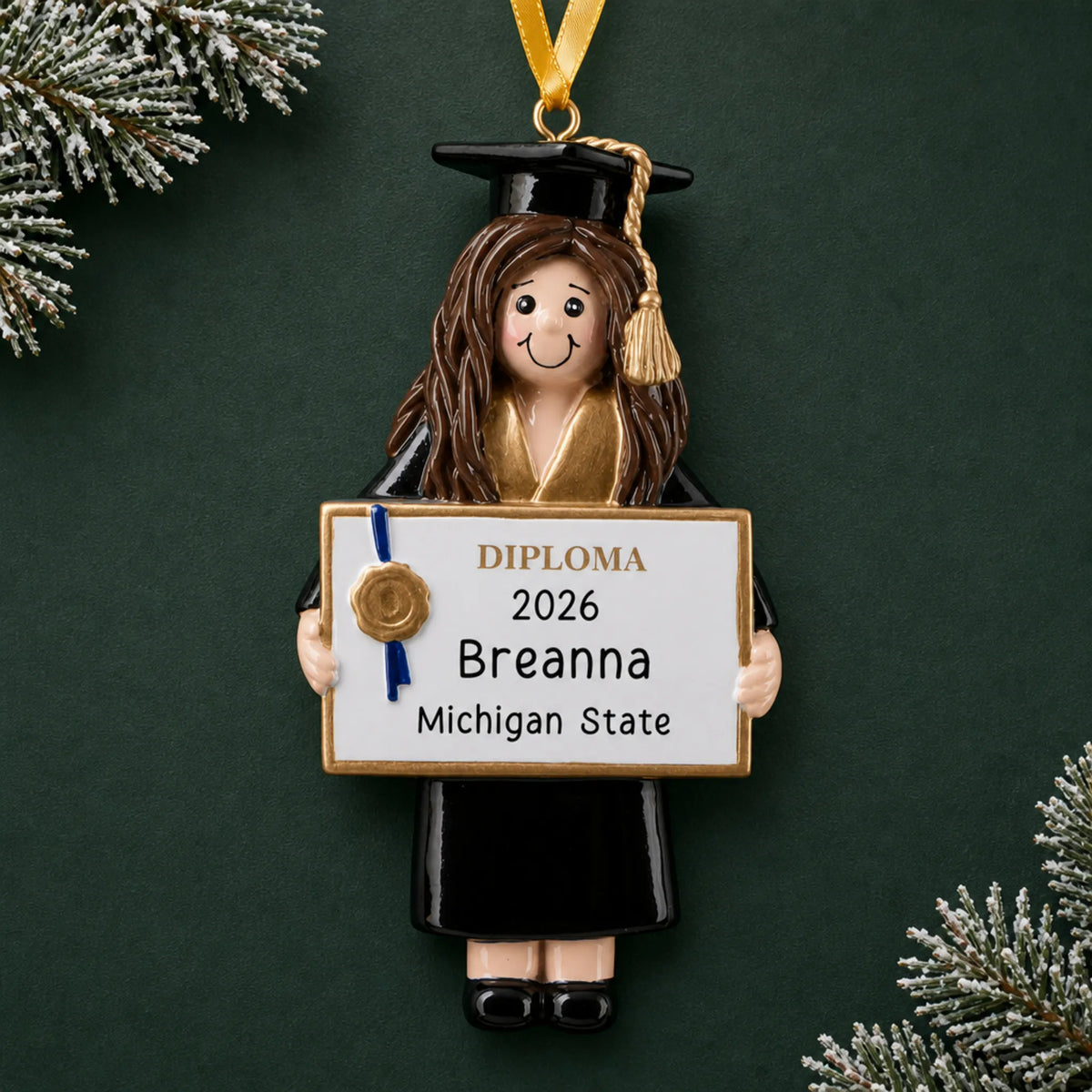 Personalized graduation girl Christmas ornament in black cap and gown holding a diploma with name, school and year