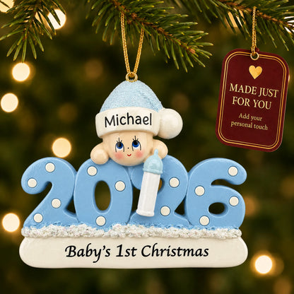 Baby boy's 1st christmas 2026 ornament hanging on a lit Christmas tree with a Made Just For You gift tag