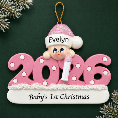 Personalized baby girl's 1st christmas 2026 ornament on a dark green pine background