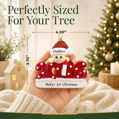 Size guide: the personalized baby's 1st christmas 2026 ornament is 4.50 in wide by 3.75 in tall, shown in hand