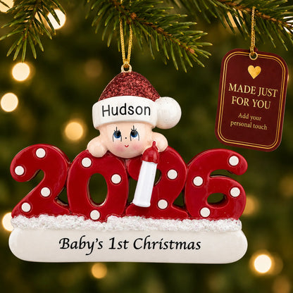 Baby's 1st christmas 2026 ornament hanging on a lit Christmas tree with a Made Just For You gift tag