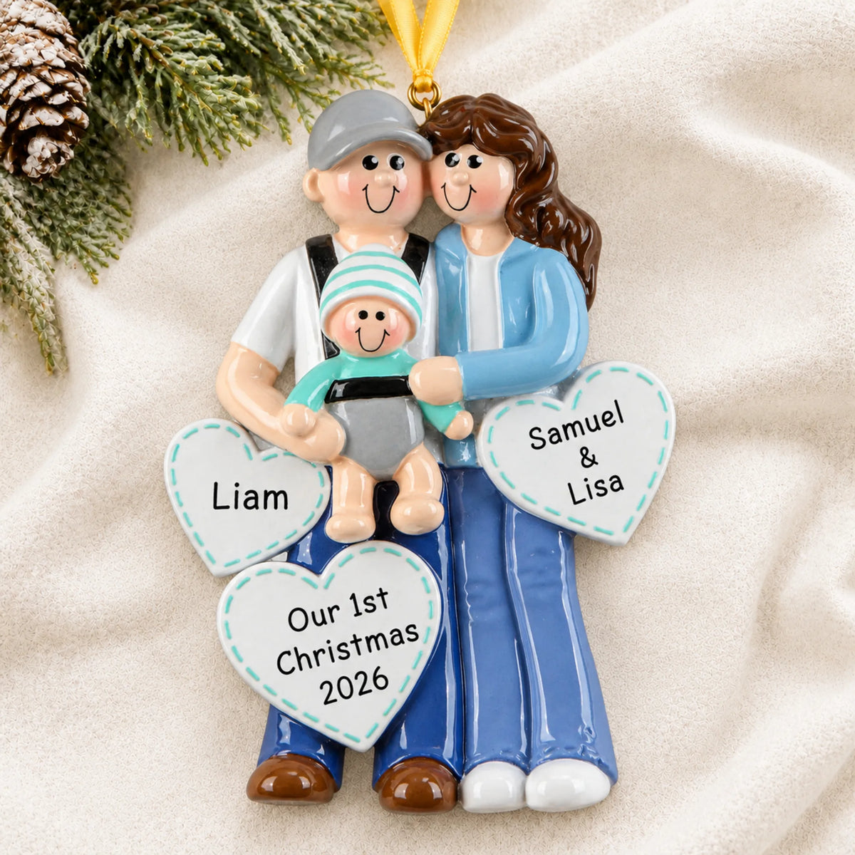 Personalized new parents with baby christmas ornament laid on a soft white knit blanket