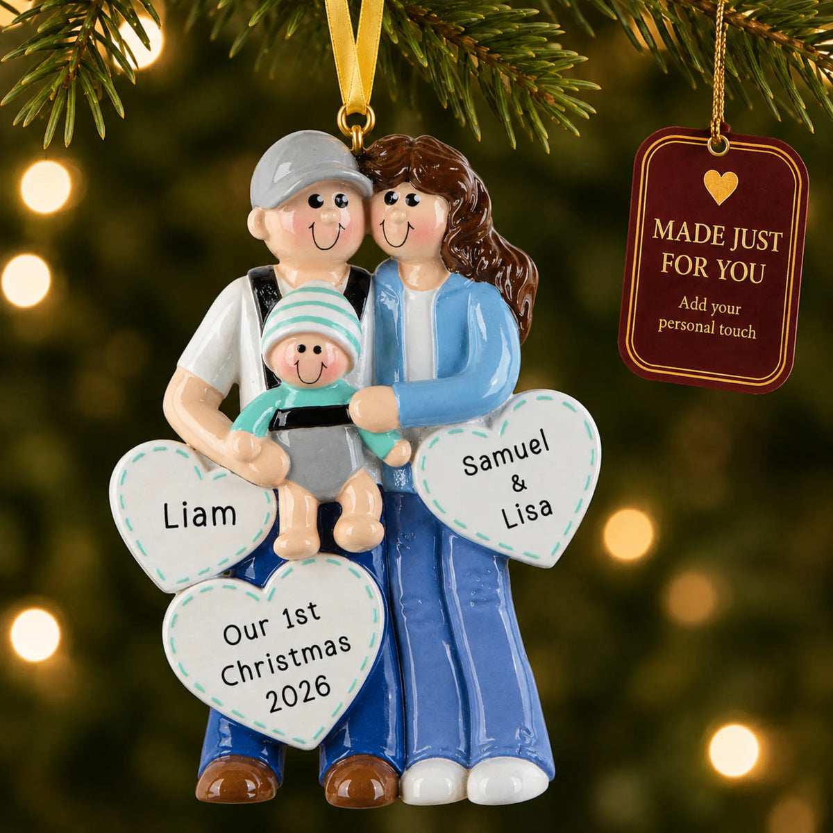 New parents with baby christmas ornament hanging on a lit Christmas tree with a Made Just For You gift tag