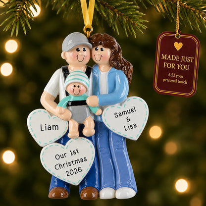 New parents with baby christmas ornament hanging on a lit Christmas tree with a Made Just For You gift tag
