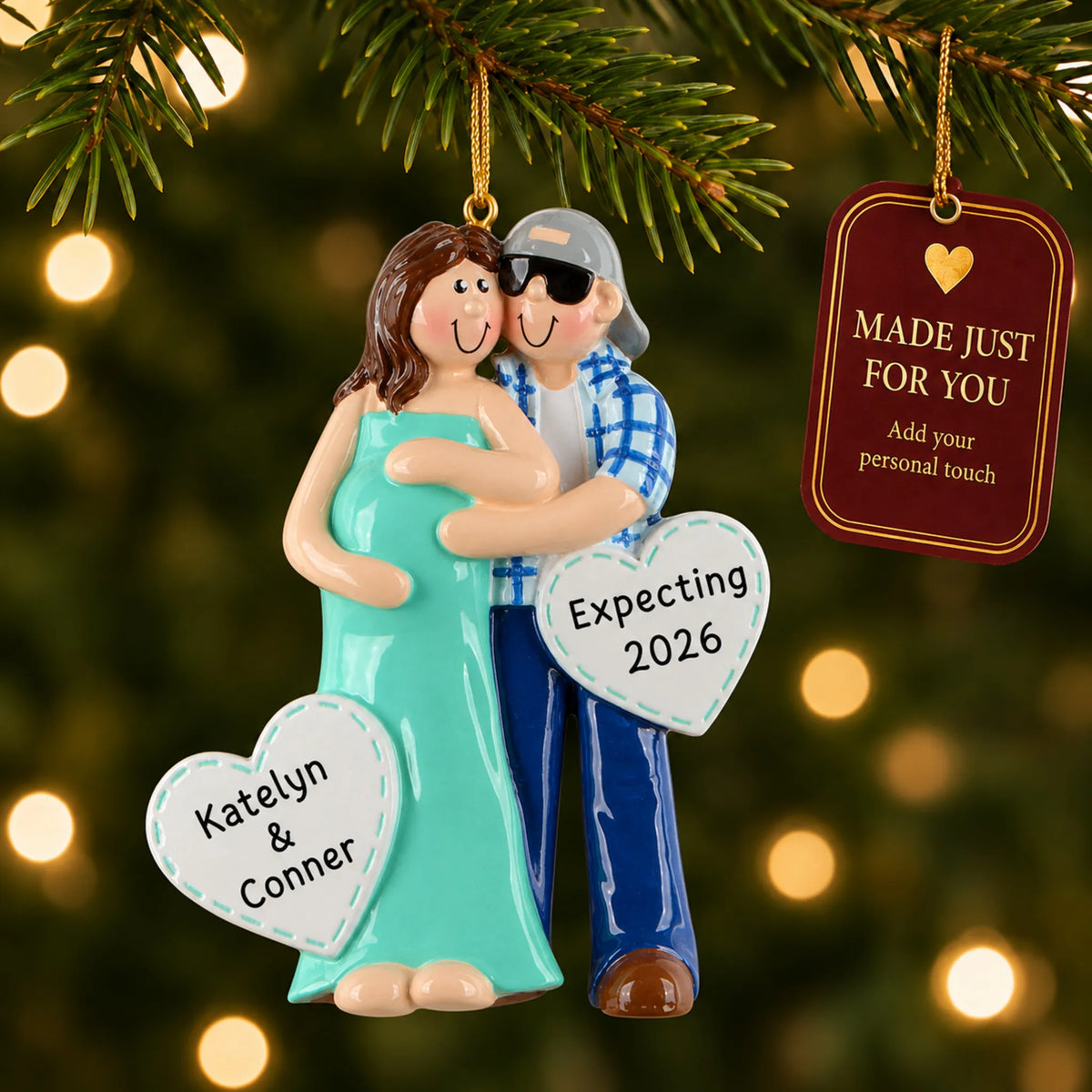 Expecting Couple christmas ornament hanging on a lit Christmas tree with a Made Just For You gift tag