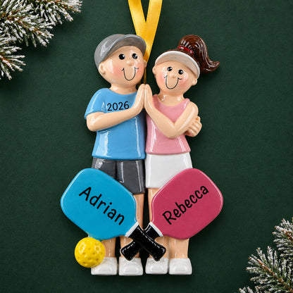 Personalized pickleball couple christmas ornament on a dark green pine background