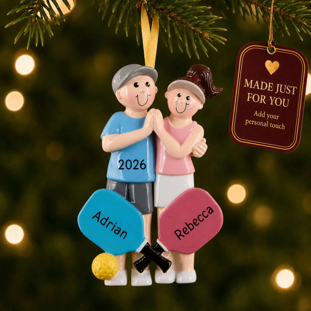 Pickleball couple christmas ornament hanging on a lit Christmas tree with a Made Just For You gift tag