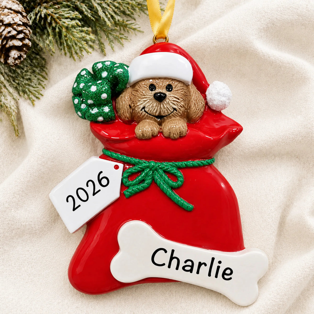 Personalized Puppy Dog christmas ornament laid on a soft white knit blanket