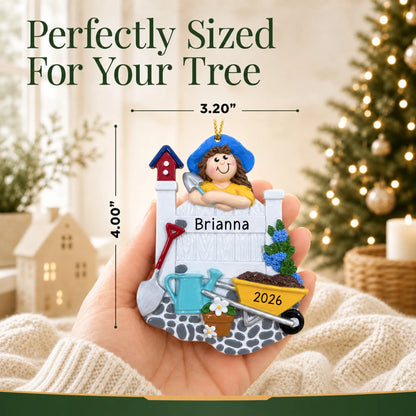 Size guide: the personalized woman gardener christmas ornament is 3.20 in wide by 4.00 in tall, shown in hand