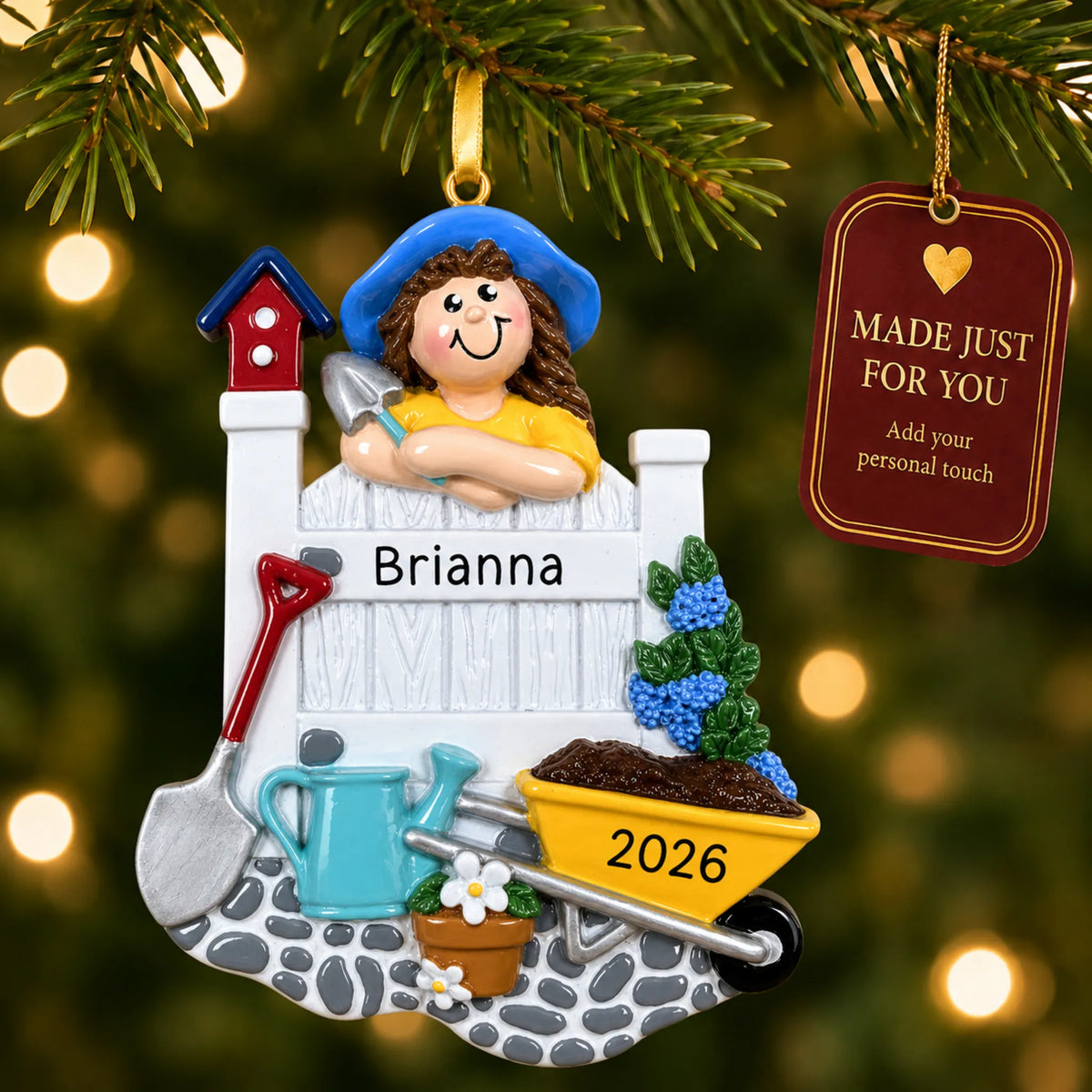 Woman gardener christmas ornament hanging on a lit Christmas tree with a Made Just For You gift tag