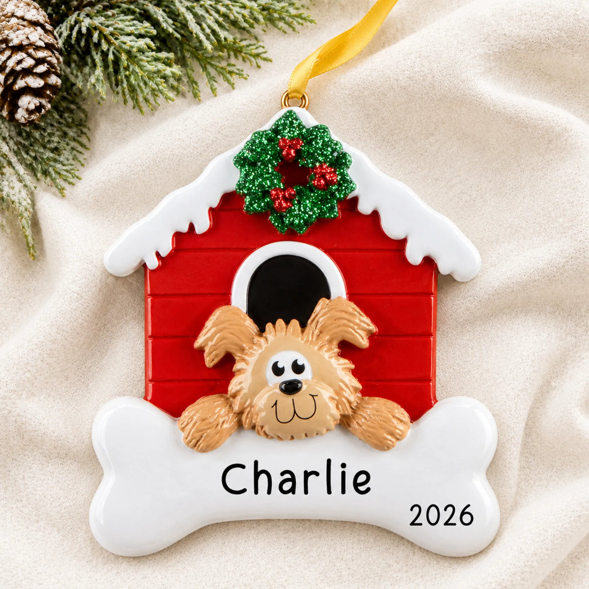 Personalized Brown Dog House christmas ornament laid on a soft white knit blanket