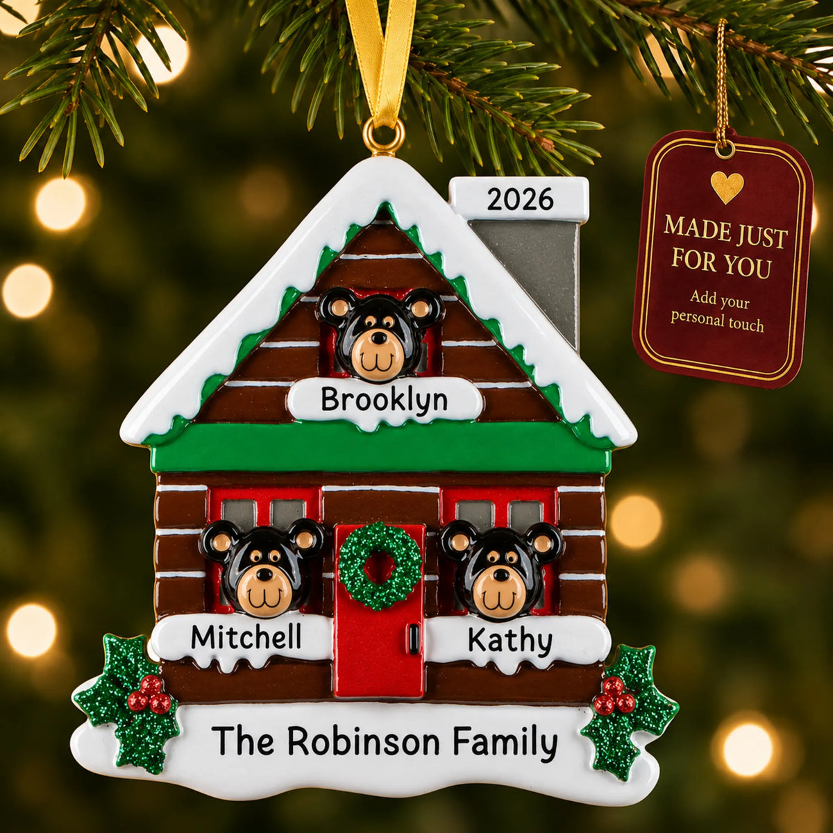 Mountain cabin family of 3 christmas ornament hanging on a lit Christmas tree with a Made Just For You gift tag