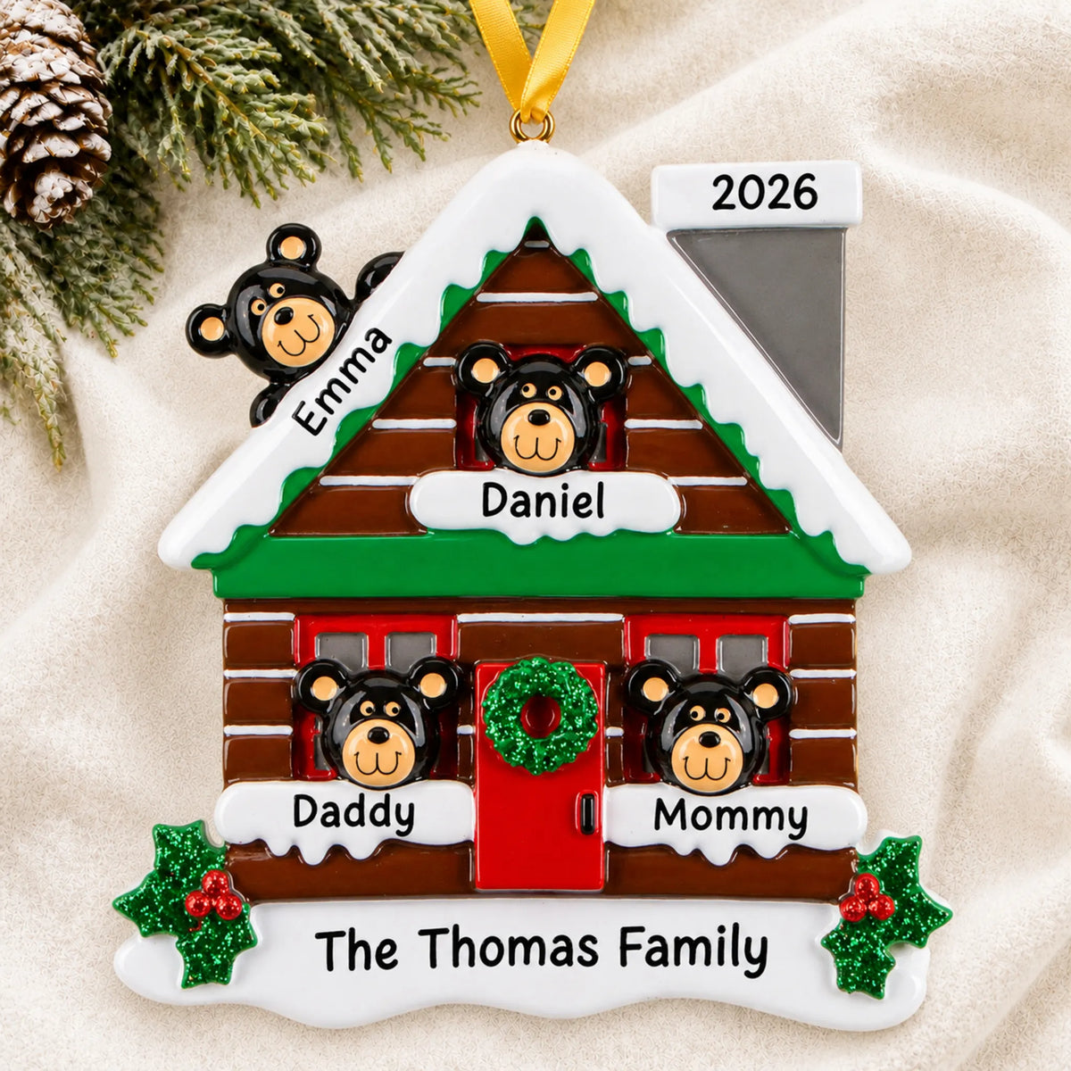 Personalized mountain cabin family of 4 christmas ornament laid on a soft white knit blanket