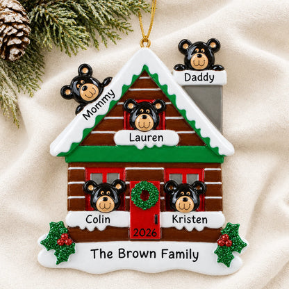 Personalized mountain cabin family of 5 christmas ornament laid on a soft white knit blanket