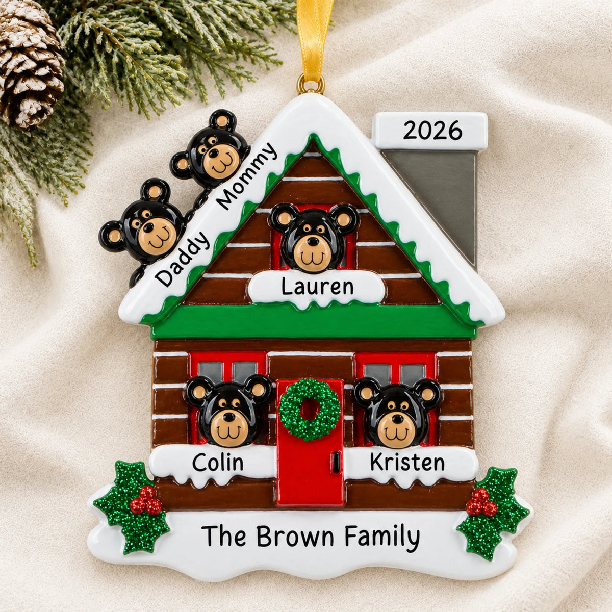 Personalized mountain cabin family of 5 christmas ornament laid on a soft white knit blanket