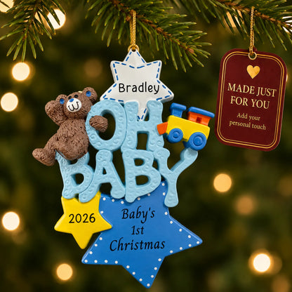 Oh baby boy 1st christmas ornament hanging on a lit Christmas tree with a Made Just For You gift tag