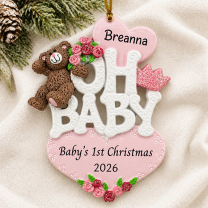 Personalized oh baby girl 1st christmas ornament laid on a soft white knit blanket