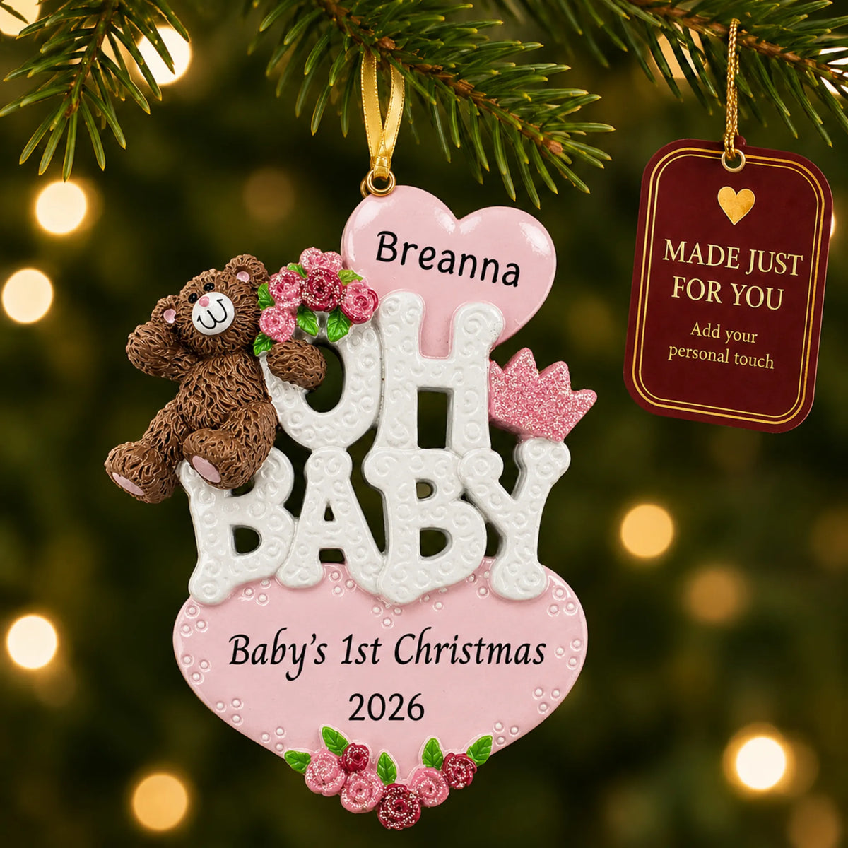 Oh baby girl 1st christmas ornament hanging on a lit Christmas tree with a Made Just For You gift tag