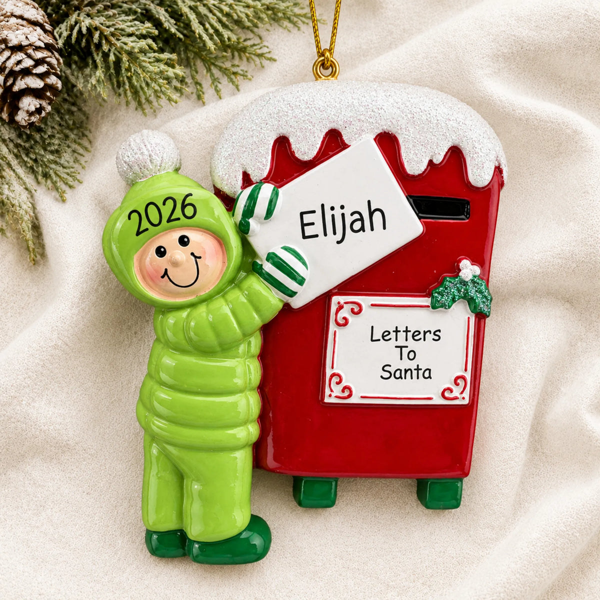 Personalized letters to santa christmas ornament laid on a soft white knit blanket