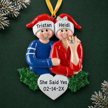Personalized Engaged Couple christmas ornament on a dark green pine background