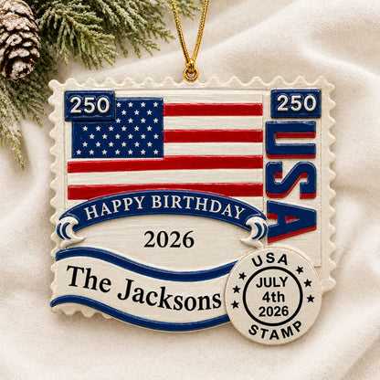 Personalized USA 250th Anniversary Stamp christmas ornament laid on a soft white knit blanket