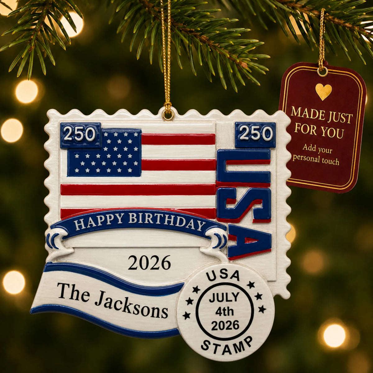 Personalized USA 250th anniversary stamp Christmas ornament hanging among tree lights with a Made Just For You tag
