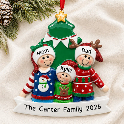 Personalized ugly sweater family of 3 christmas ornament laid on a soft white knit blanket