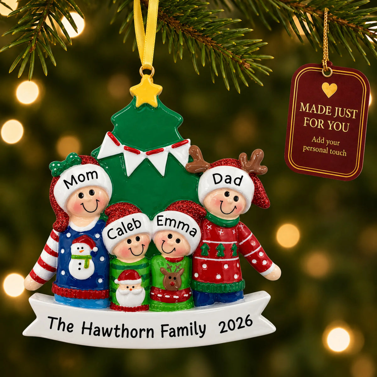Ugly sweater family of 4 christmas ornament hanging on a lit Christmas tree with a Made Just For You gift tag