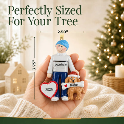 Size guide: the personalized Man and Dog christmas ornament is 2.50 in wide by 3.75 in tall, shown in hand