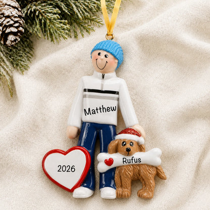 Personalized Man and Dog christmas ornament laid on a soft white knit blanket