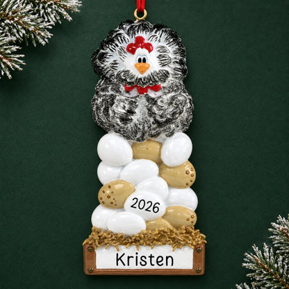 Personalized chicken laying eggs christmas ornament on a dark green pine background