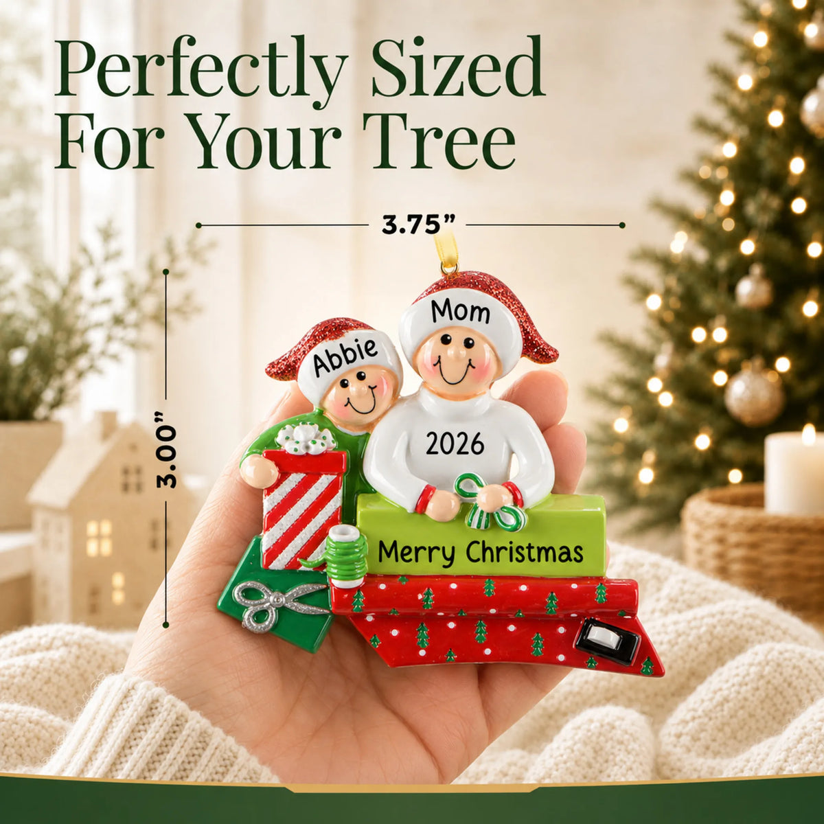 Size guide: the personalized single parent & child christmas ornament is 3.75 in wide by 3.00 in tall, shown in hand