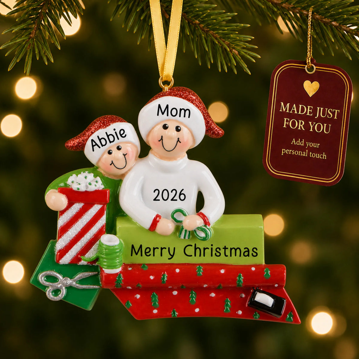 Single parent & child christmas ornament hanging on a lit Christmas tree with a Made Just For You gift tag