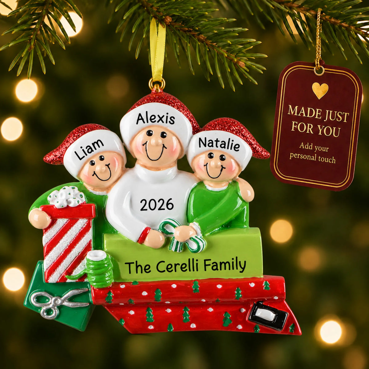 Single parent & 2 children christmas ornament hanging on a lit Christmas tree with a Made Just For You gift tag