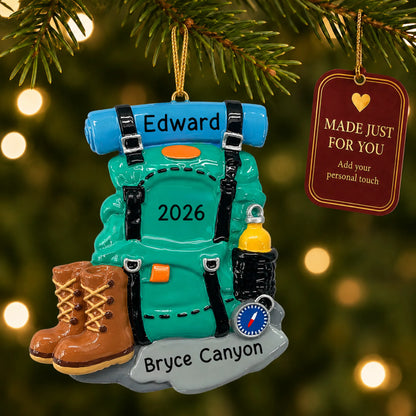Hiking backpack christmas ornament hanging on a lit Christmas tree with a Made Just For You gift tag
