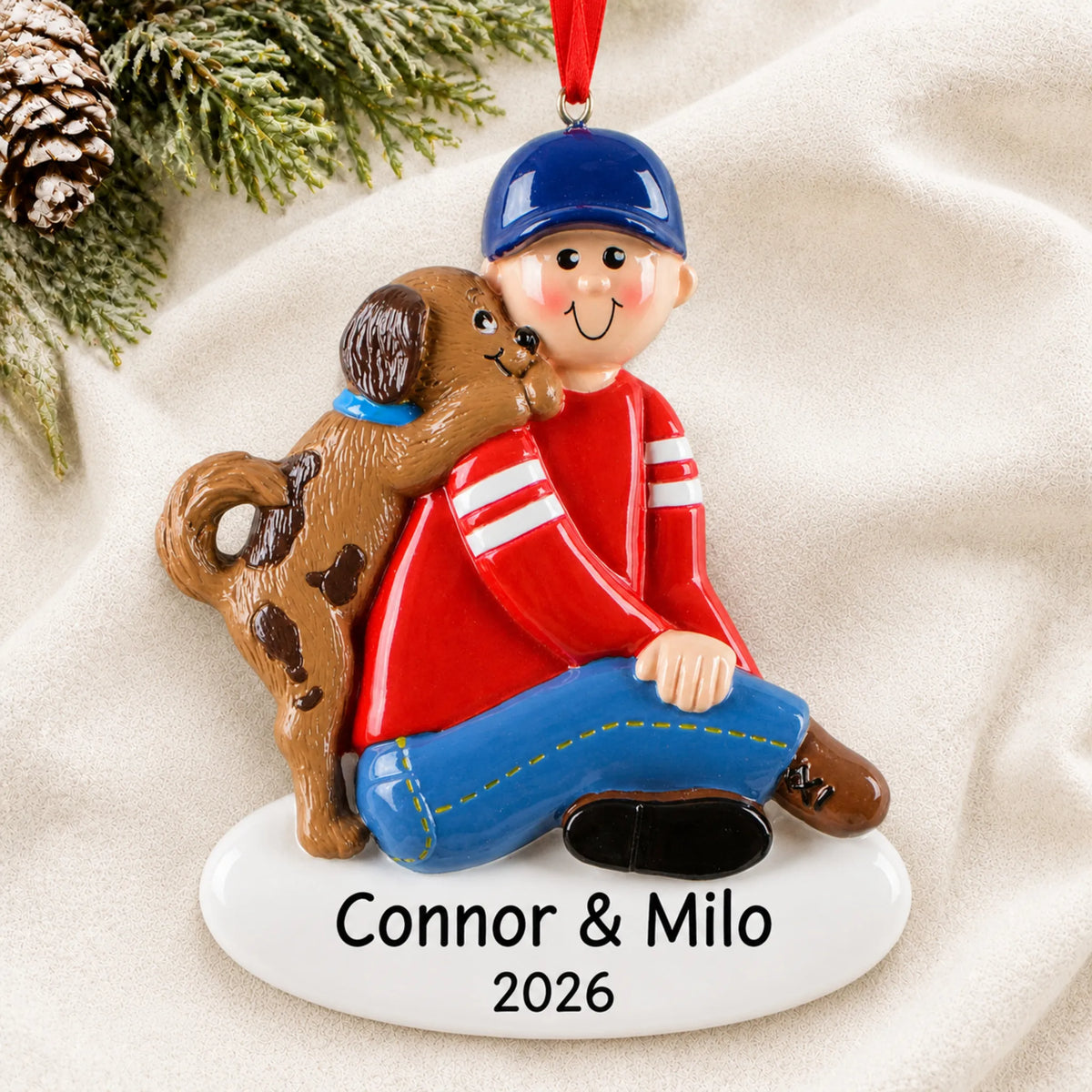 Personalized Boy With Puppy christmas ornament laid on a soft white knit blanket