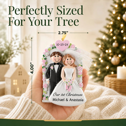 Size guide: the personalized Wedding Arch Just Married christmas ornament is 2.75 in wide by 4.00 in tall, shown in hand