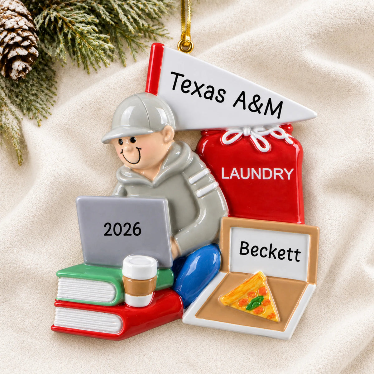 Personalized college dorm guy christmas ornament laid on a soft white knit blanket
