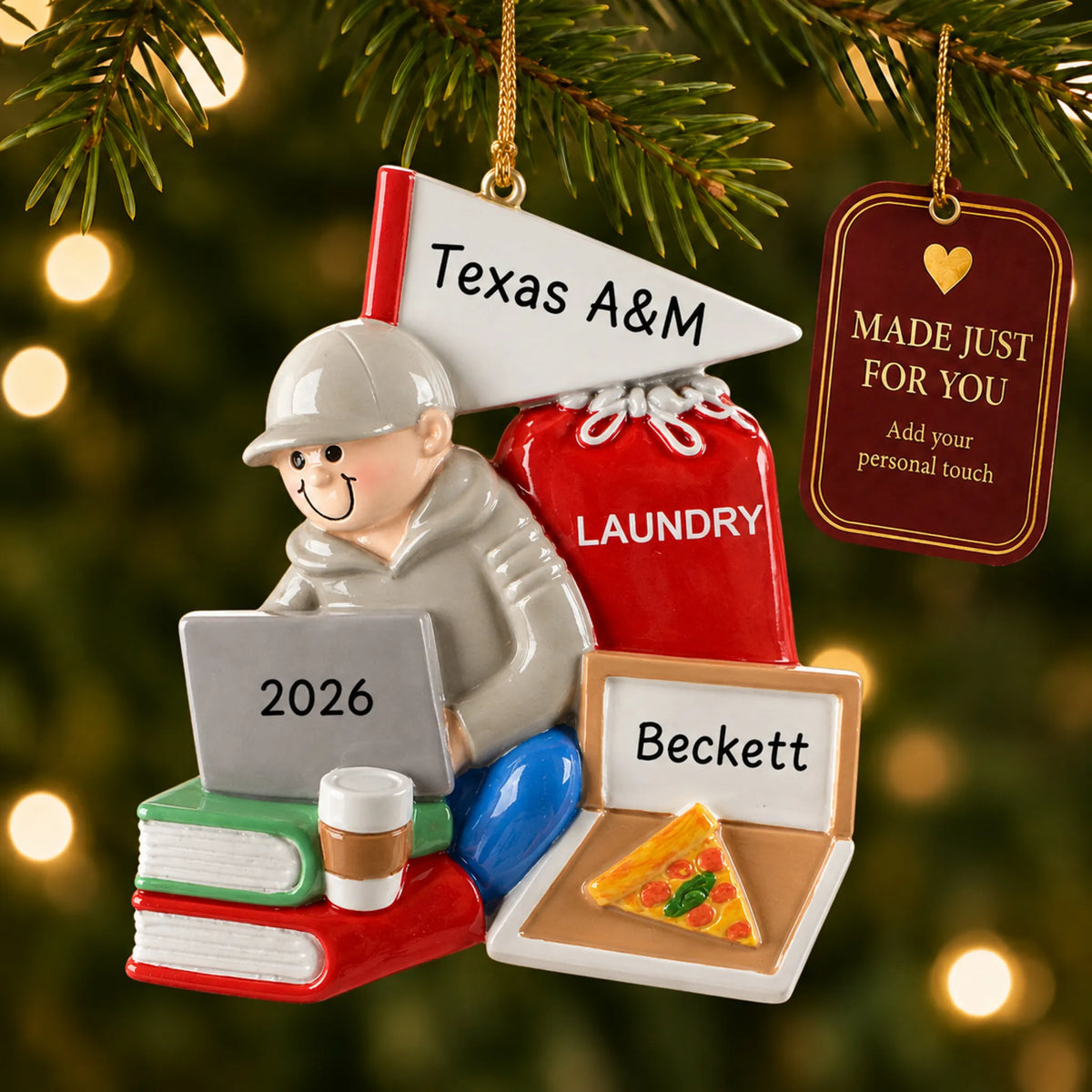 College dorm guy christmas ornament hanging on a lit Christmas tree with a Made Just For You gift tag