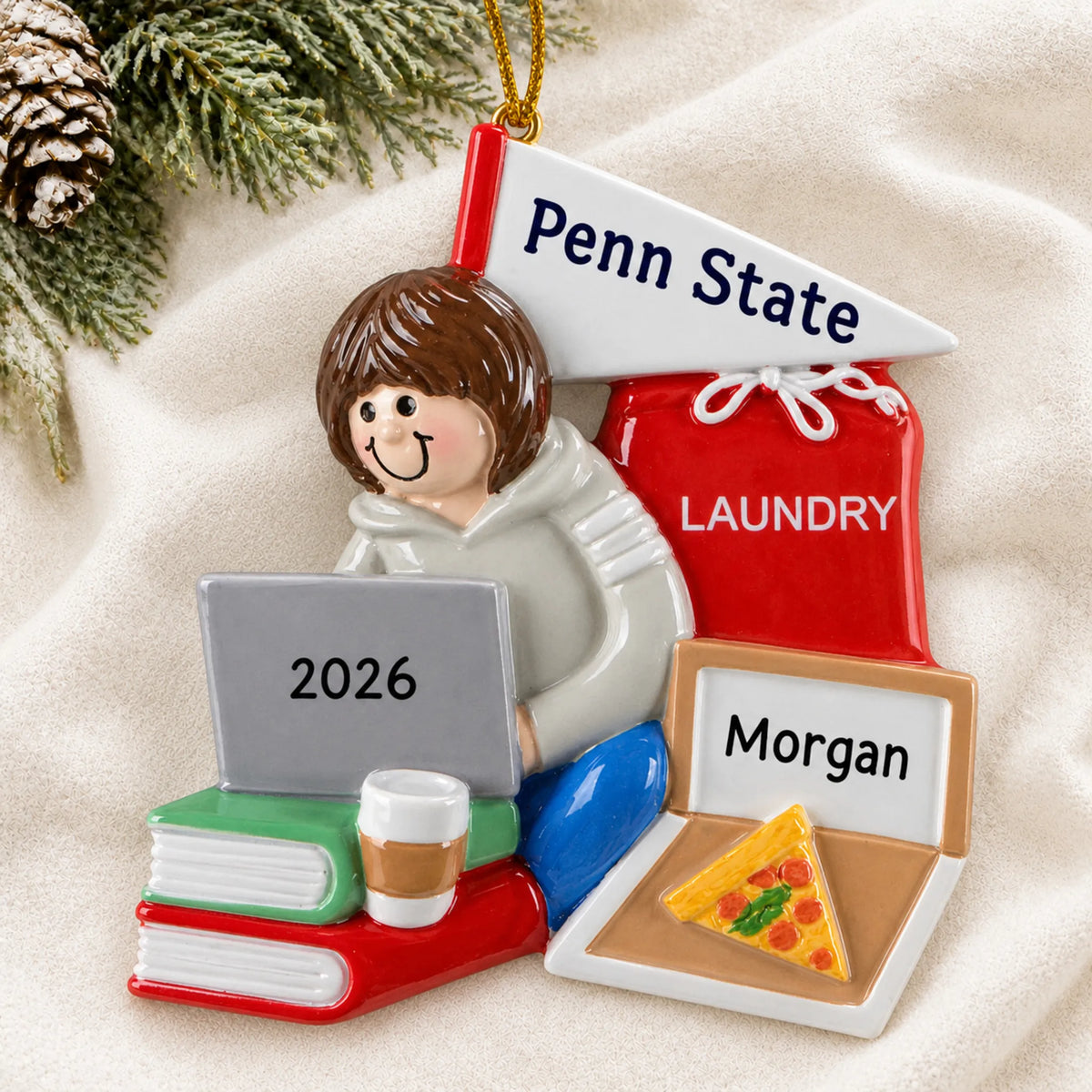 Personalized college dorm girl christmas ornament laid on a soft white knit blanket