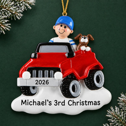 Personalized boys ride on electric car christmas ornament on a dark green pine background