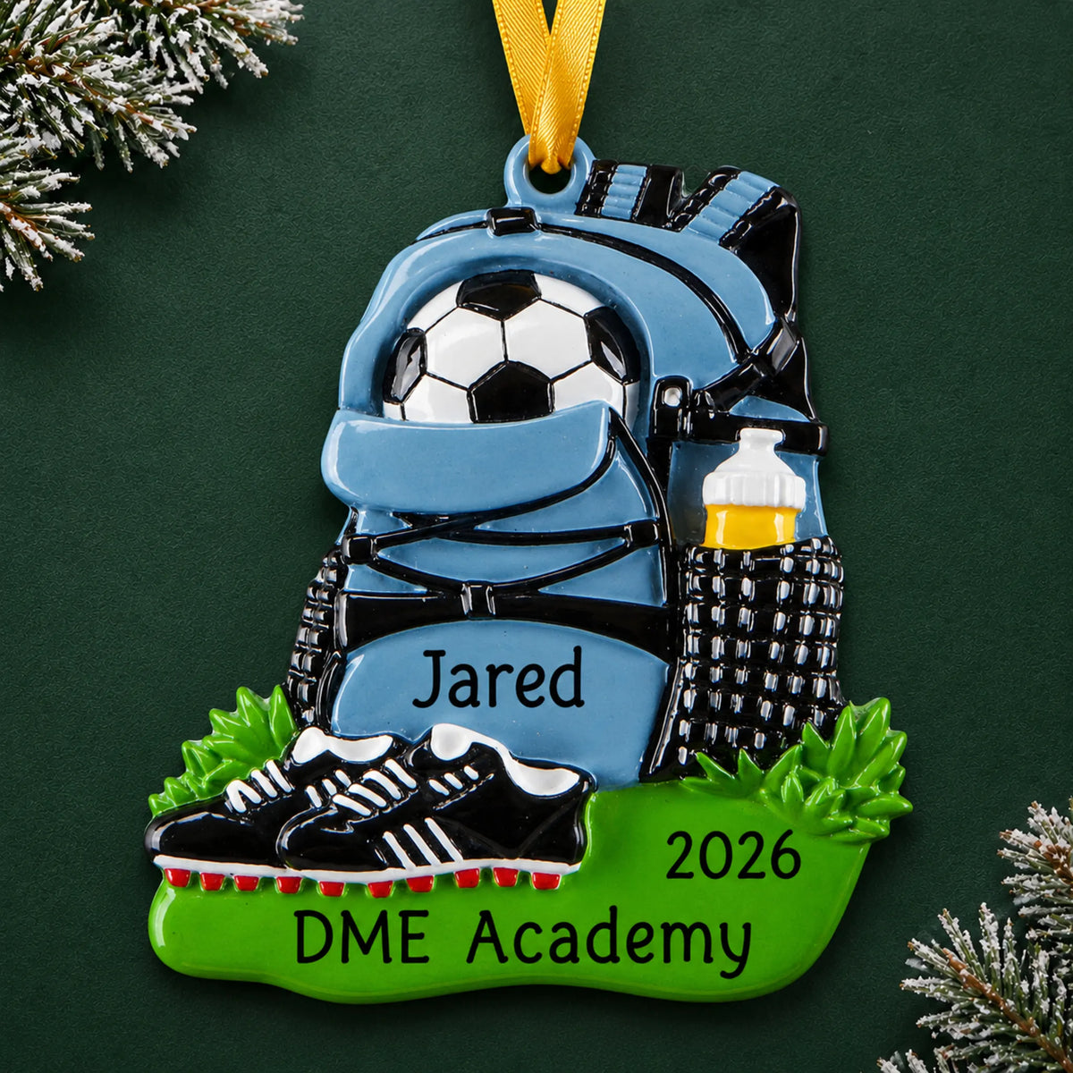 Personalized soccer gear christmas ornament on a dark green pine background