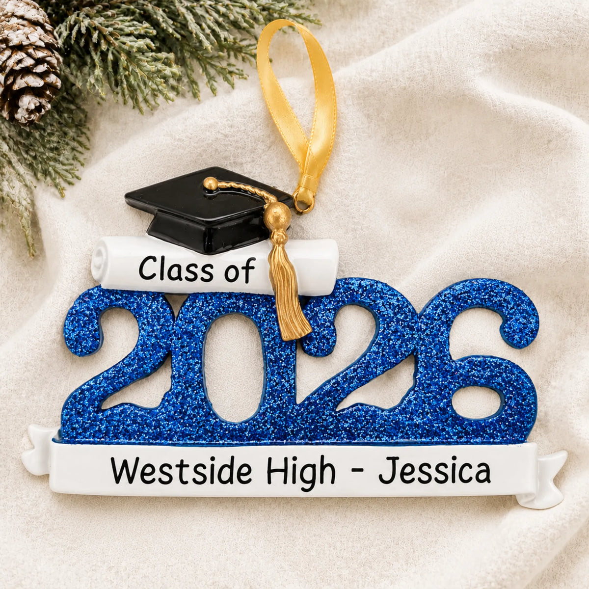 Front view of the personalized Class of 2026 blue graduation Christmas ornament with grad cap and school banner