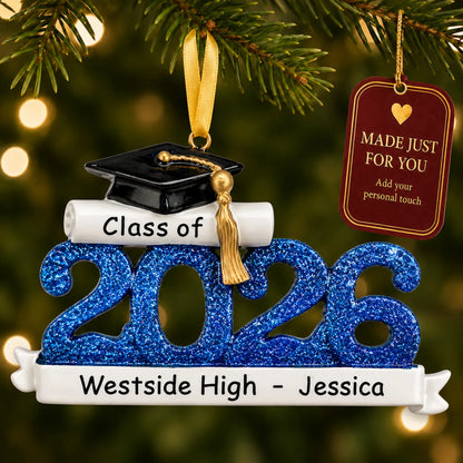 Personalized Class of 2026 blue graduation Christmas ornament on a lit tree with a made-just-for-you tag