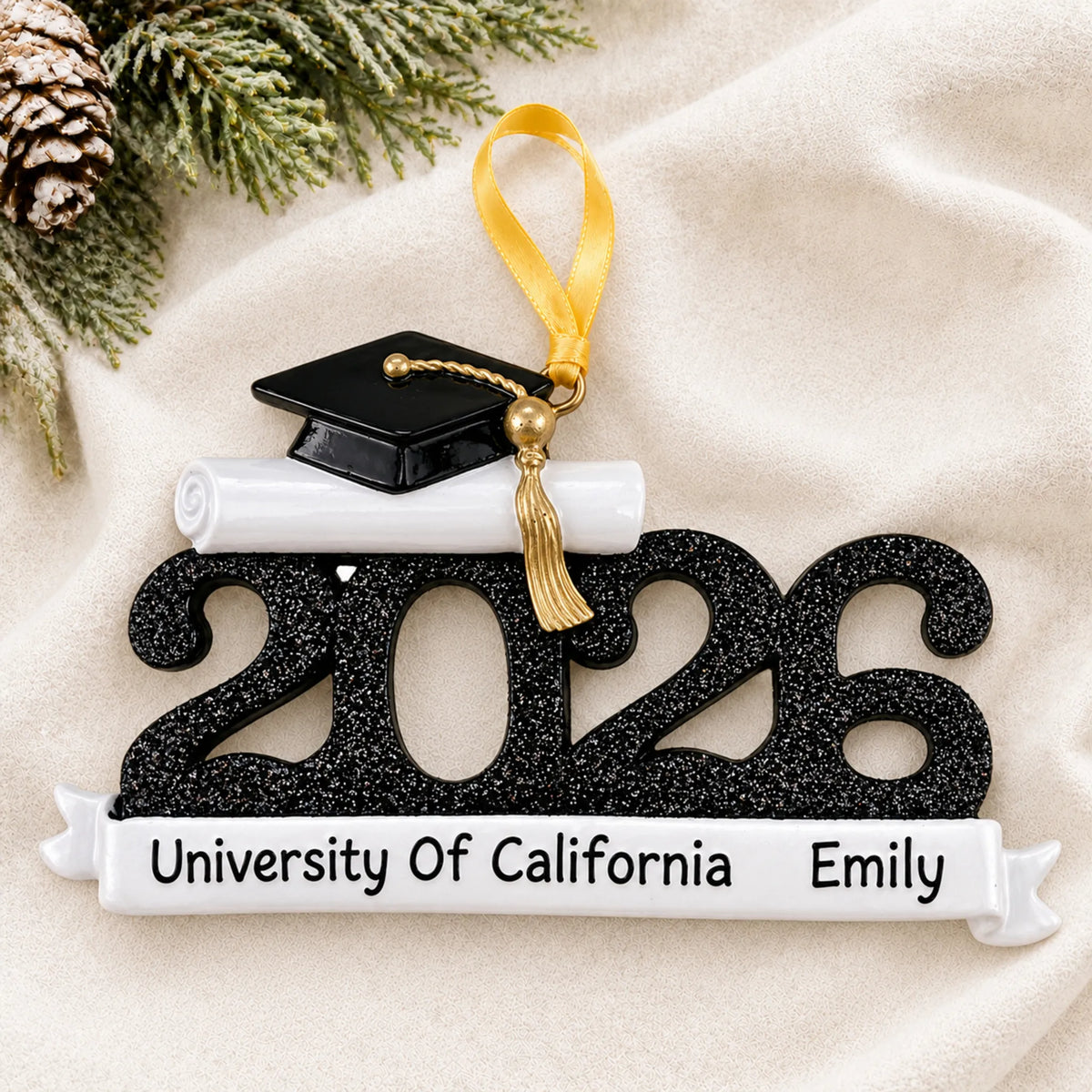 Front view of the personalized Class of 2026 black graduation Christmas ornament with grad cap and school banner