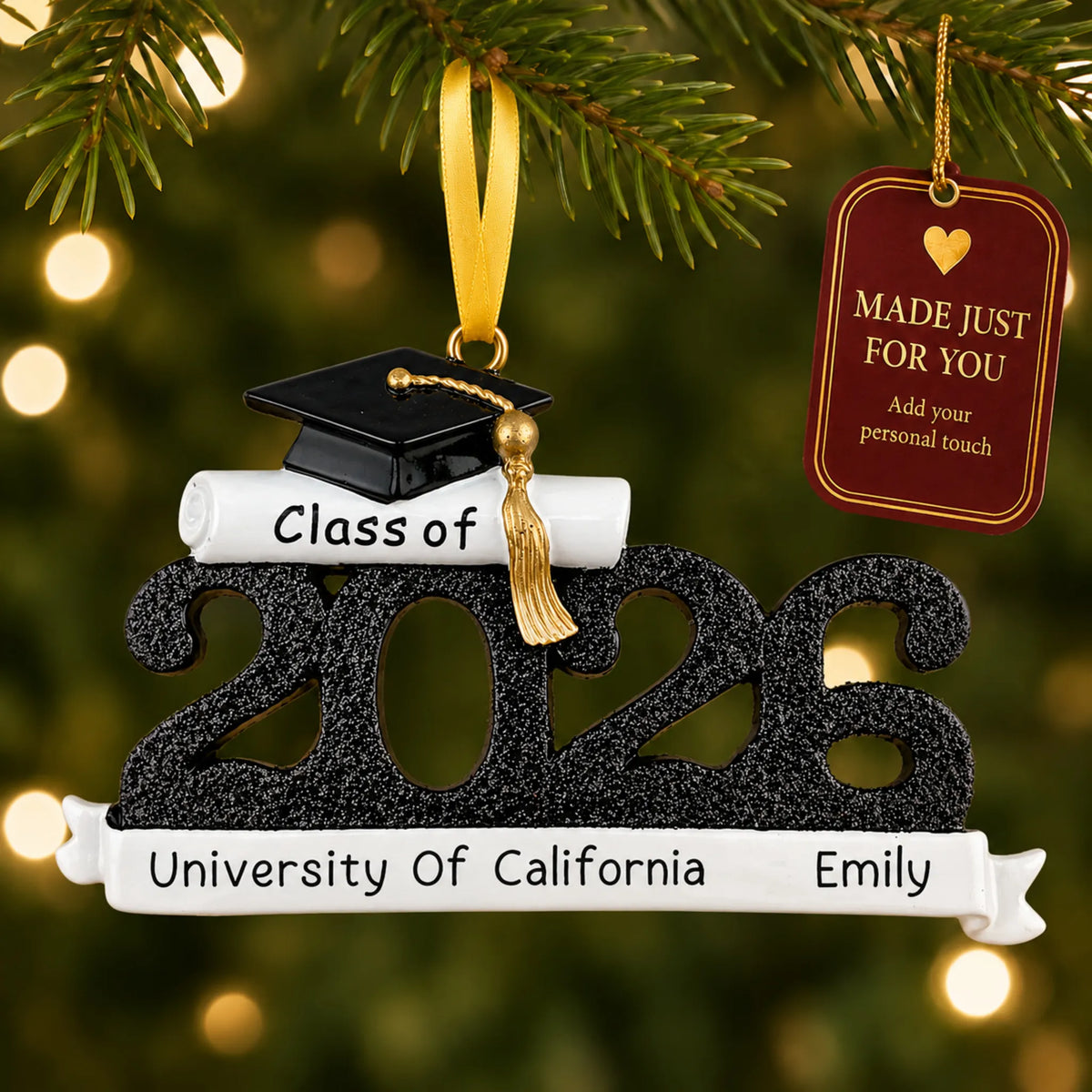 Personalized Class of 2026 black graduation Christmas ornament on a lit tree with a made-just-for-you tag