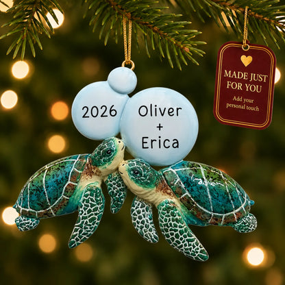 Sea turtle couple christmas ornament hanging on a lit Christmas tree with a Made Just For You gift tag