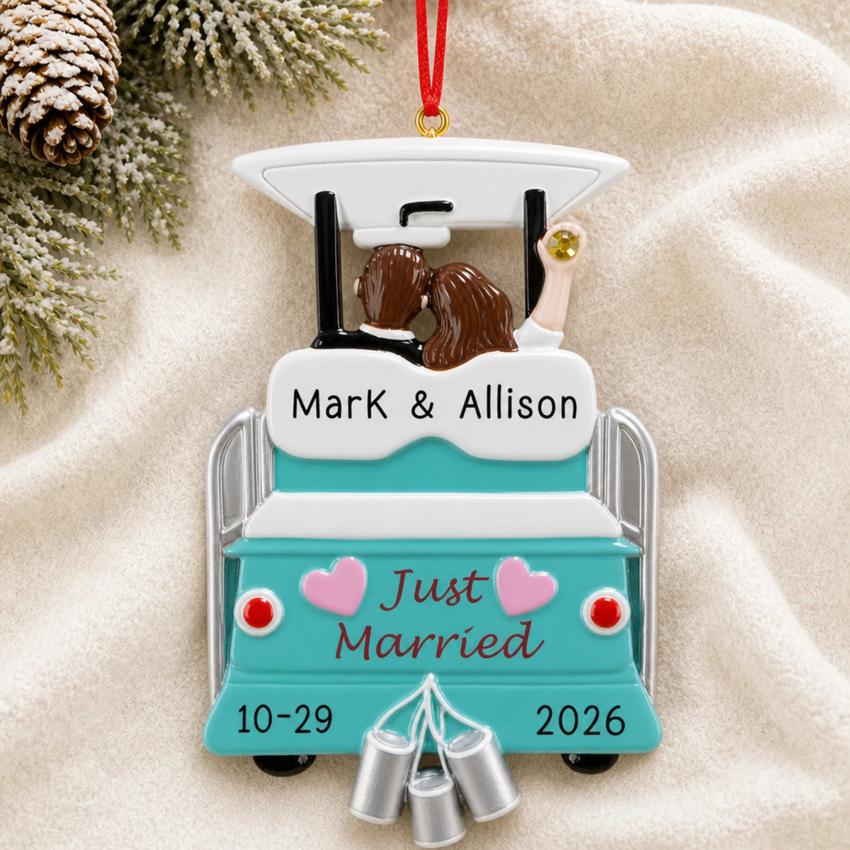 Personalized Just Married Wedding christmas ornament laid on a soft white knit blanket